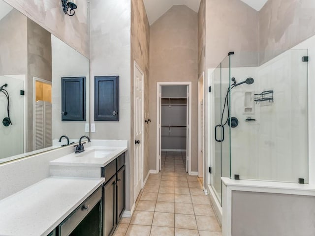 bathroom with tile patterned floors, vanity, high vaulted ceiling, and a shower with door