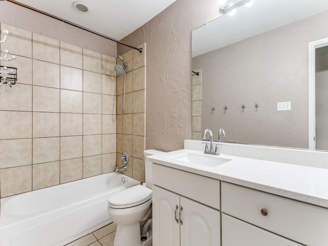 full bathroom featuring tile patterned flooring, vanity, toilet, and tiled shower / bath