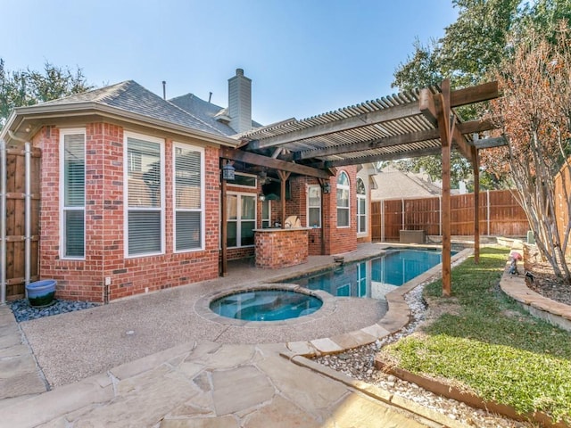 view of swimming pool with an in ground hot tub and a pergola