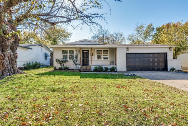 ranch-style house featuring a garage and a front lawn