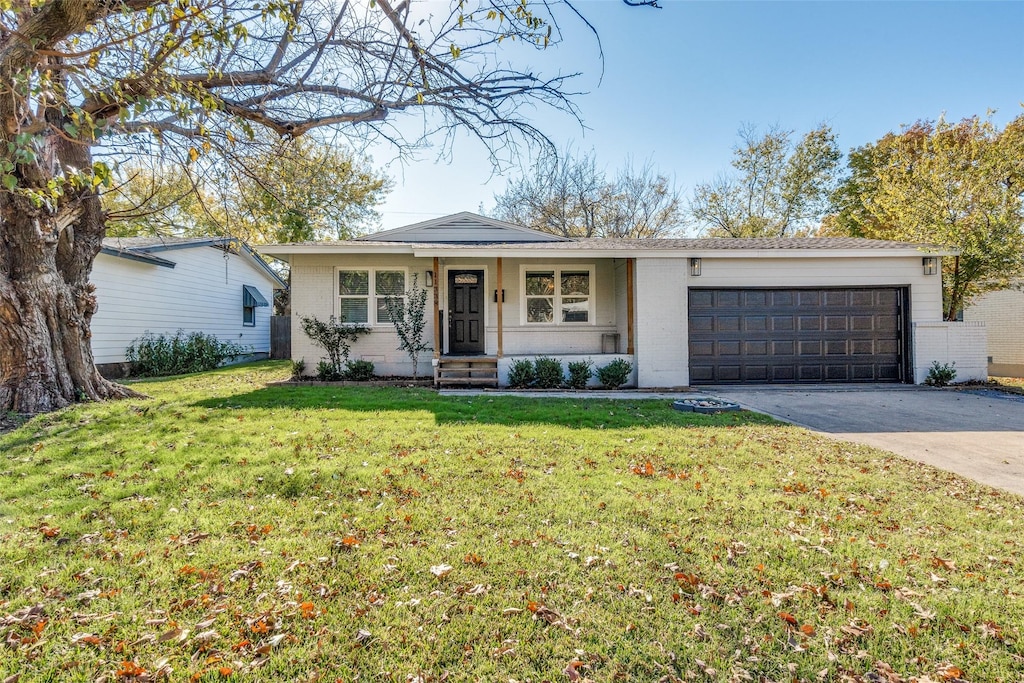 ranch-style home featuring a garage and a front yard