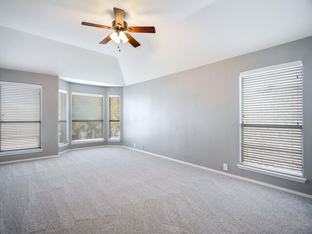 empty room featuring light colored carpet, ceiling fan, and lofted ceiling