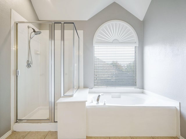 bathroom featuring separate shower and tub, tile patterned floors, and lofted ceiling