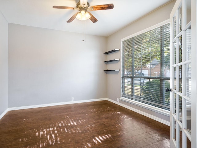 spare room featuring french doors, plenty of natural light, dark wood-type flooring, and ceiling fan