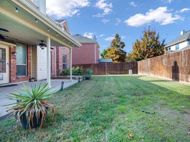 view of yard featuring ceiling fan and a patio