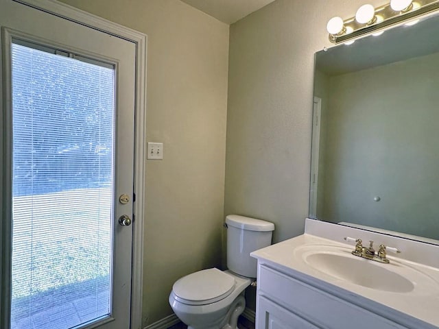 bathroom featuring vanity and toilet