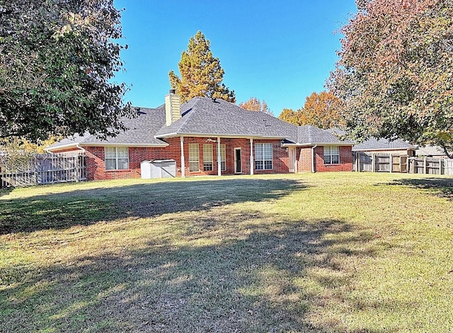 rear view of house featuring a lawn