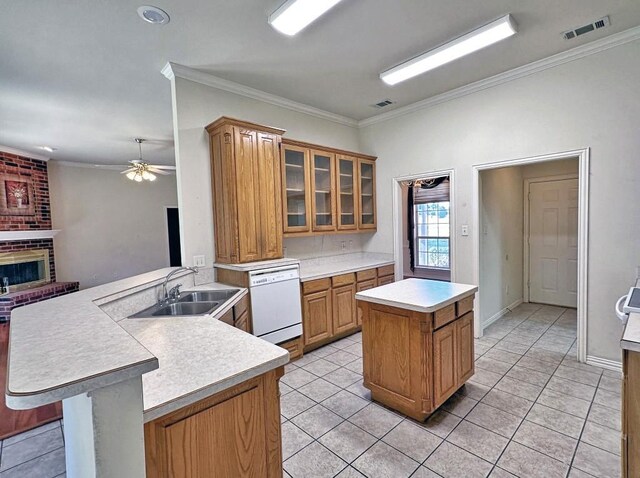 kitchen featuring dishwasher, sink, kitchen peninsula, crown molding, and a kitchen island