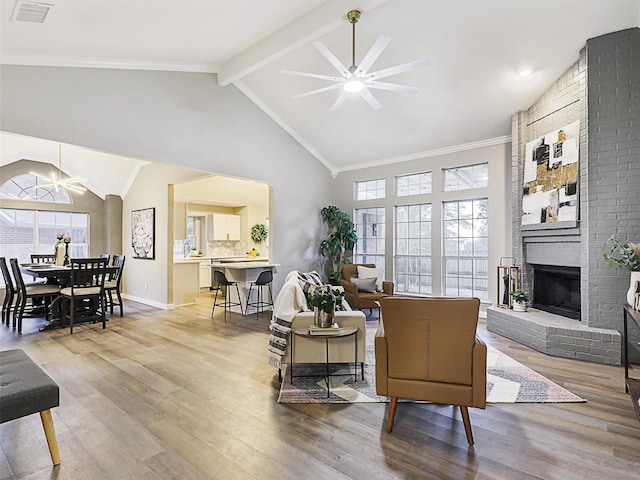 living room featuring plenty of natural light, ceiling fan, and wood-type flooring