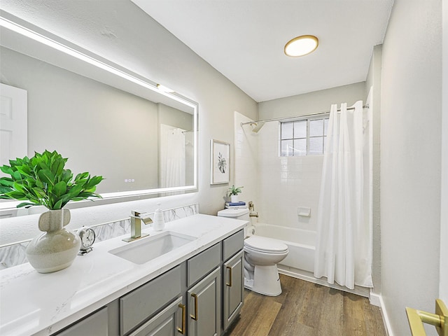 full bathroom with vanity, wood-type flooring, shower / bath combo, and toilet