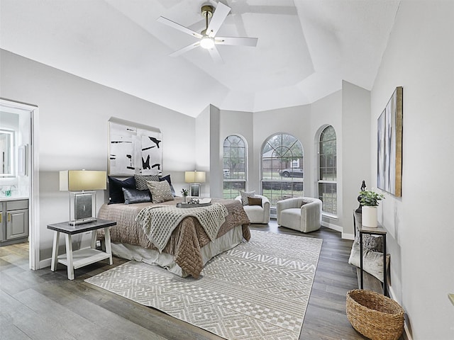 bedroom with wood-type flooring, connected bathroom, and ceiling fan