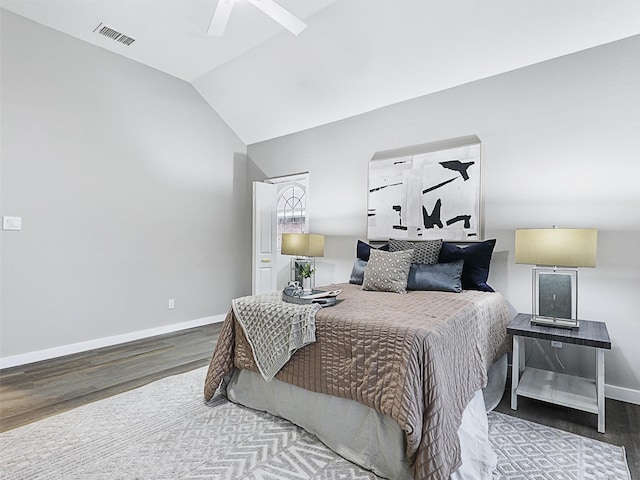 bedroom with ceiling fan, wood-type flooring, and vaulted ceiling