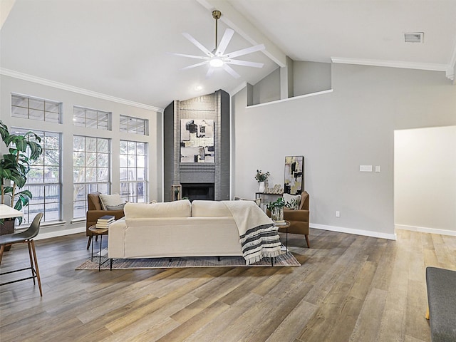 living room with ceiling fan, high vaulted ceiling, ornamental molding, and hardwood / wood-style flooring