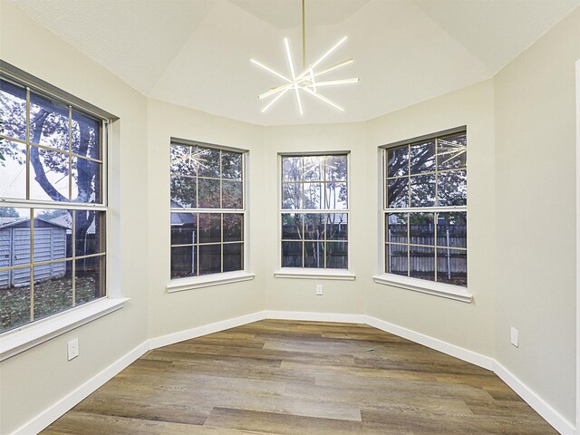 unfurnished sunroom with a notable chandelier