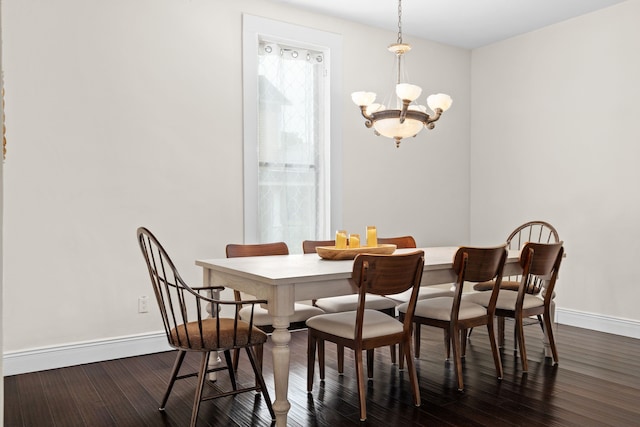 dining space with a chandelier and dark hardwood / wood-style floors