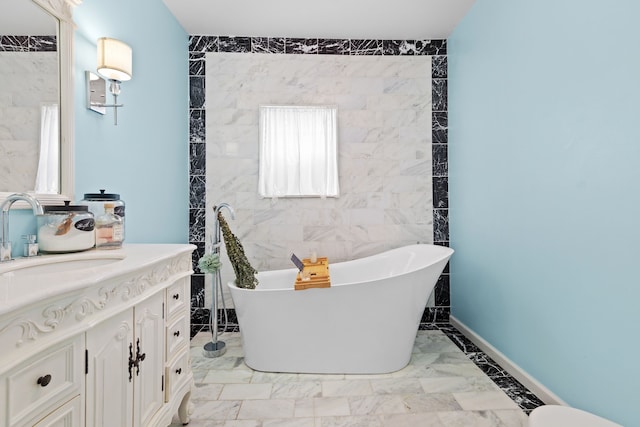 bathroom featuring a bathtub, tile walls, and vanity