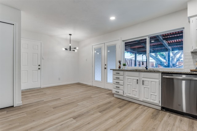 kitchen with white cabinets, sink, decorative light fixtures, dishwasher, and light hardwood / wood-style floors