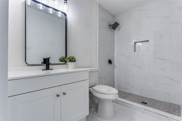 bathroom featuring vanity, toilet, and a tile shower