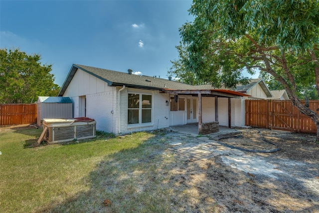 rear view of house featuring a patio area and a lawn