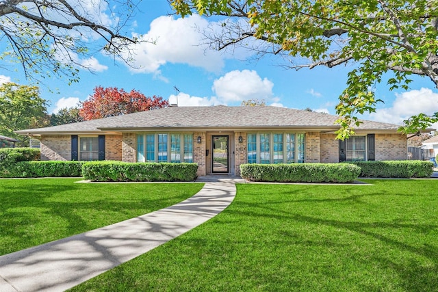 ranch-style home with a front lawn