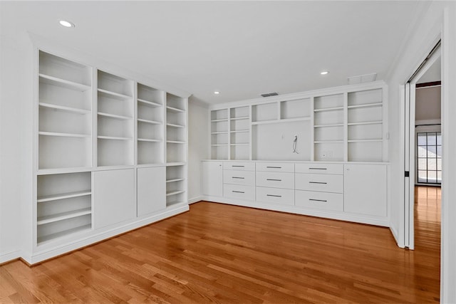 unfurnished living room with wood-type flooring