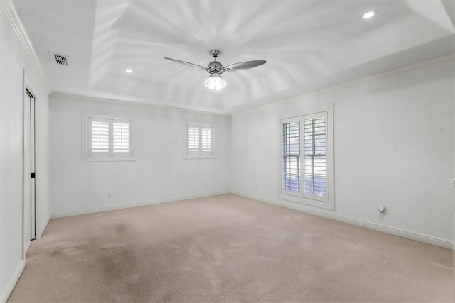 unfurnished room featuring crown molding, light colored carpet, ceiling fan, and a tray ceiling