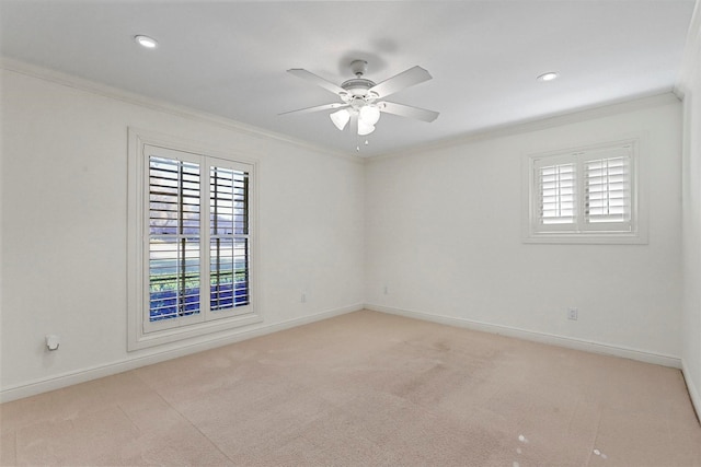 empty room with light colored carpet, ornamental molding, and ceiling fan