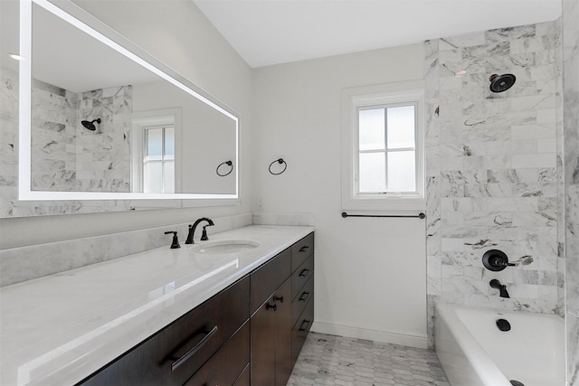 bathroom with tiled shower / bath and vanity