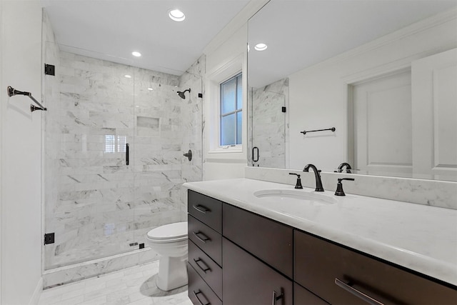 bathroom with vanity, toilet, and a shower with door