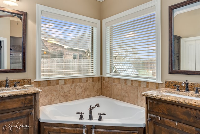 bathroom featuring vanity and a tub to relax in