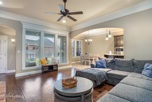 living room featuring crown molding, ceiling fan with notable chandelier, and dark hardwood / wood-style floors