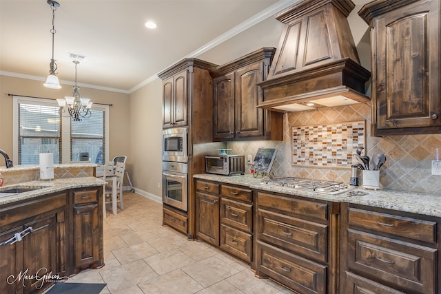 kitchen featuring light stone countertops, premium range hood, tasteful backsplash, dark brown cabinets, and an inviting chandelier