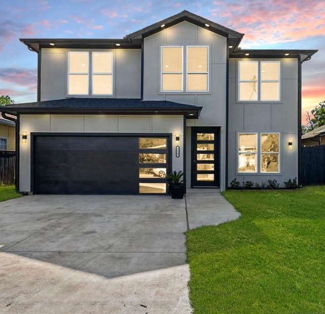 view of front of property featuring a yard and a garage