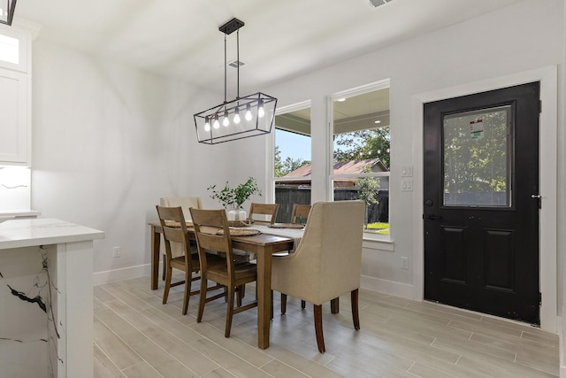 dining area featuring light wood-type flooring