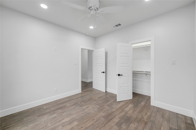 unfurnished bedroom with a closet, ceiling fan, and hardwood / wood-style flooring