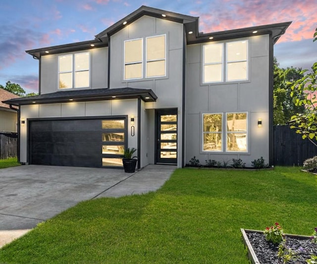 modern home featuring a yard and a garage