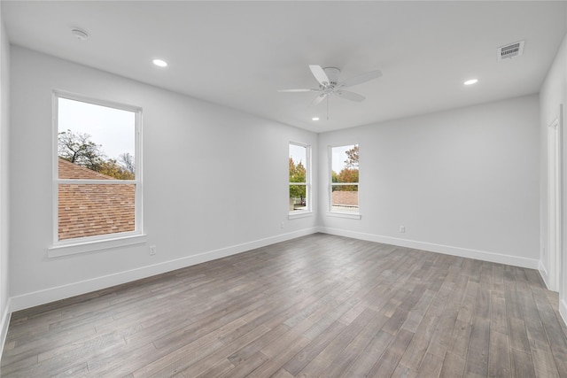 unfurnished room featuring ceiling fan and hardwood / wood-style flooring