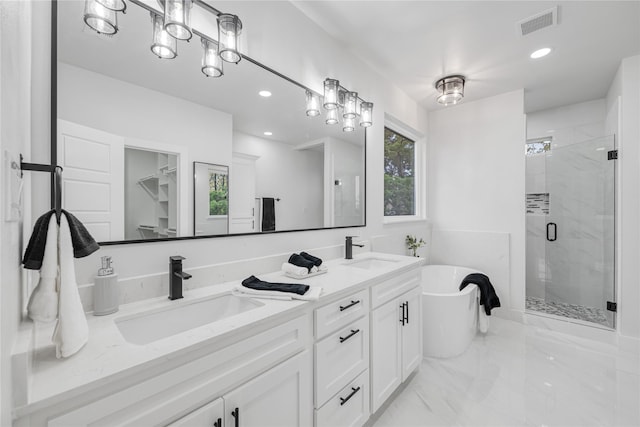 bathroom featuring vanity and independent shower and bath