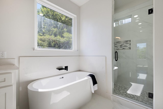 bathroom featuring tile patterned floors, vanity, and independent shower and bath