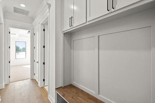 mudroom featuring light hardwood / wood-style floors and ornamental molding