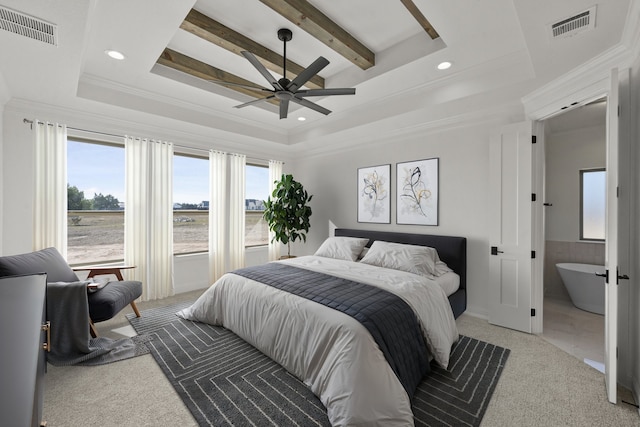 carpeted bedroom with connected bathroom, ceiling fan, a tray ceiling, and ornamental molding