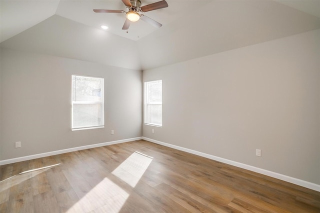 spare room featuring ceiling fan, light hardwood / wood-style floors, and vaulted ceiling