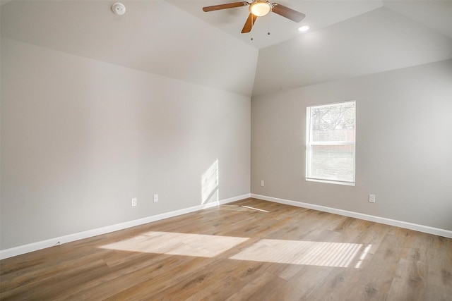 empty room with ceiling fan, light hardwood / wood-style floors, and high vaulted ceiling