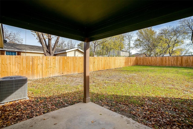 view of yard featuring central AC unit and a patio