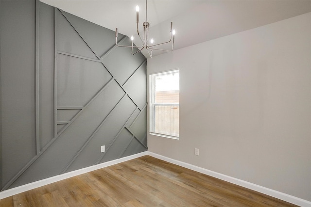 interior space with hardwood / wood-style floors and an inviting chandelier