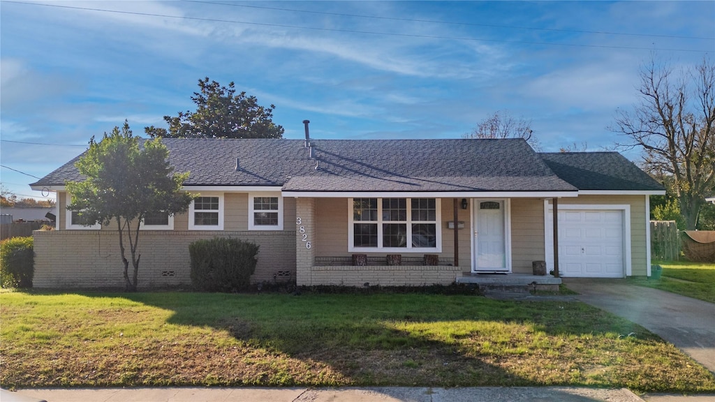 ranch-style home with a garage and a front lawn