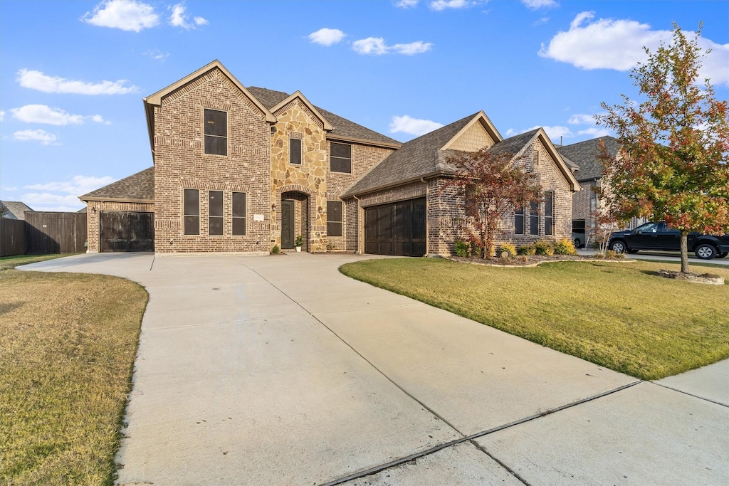 view of front of home featuring a garage and a front yard