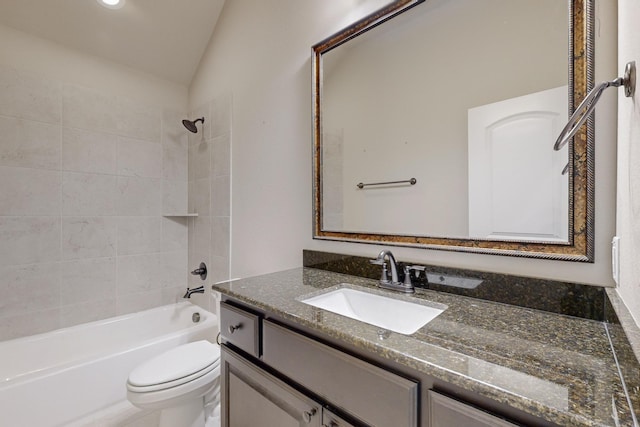 full bathroom featuring vanity, tiled shower / bath combo, lofted ceiling, and toilet