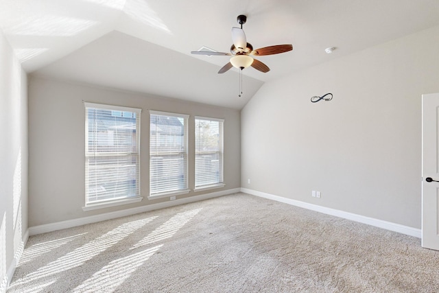 unfurnished room featuring ceiling fan, light colored carpet, and vaulted ceiling