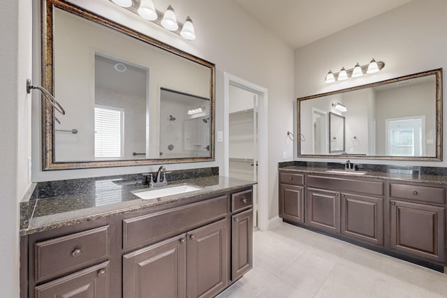 bathroom featuring walk in shower, tile patterned floors, and vanity